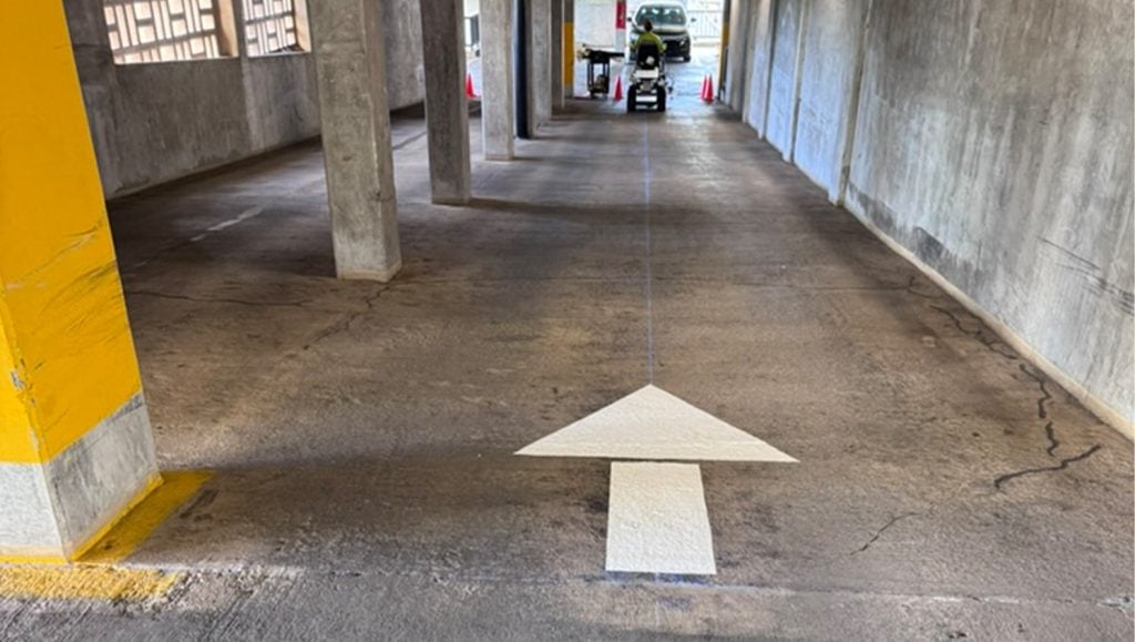 Parkland Gardens Condominium parking lot with freshly painted white arrow