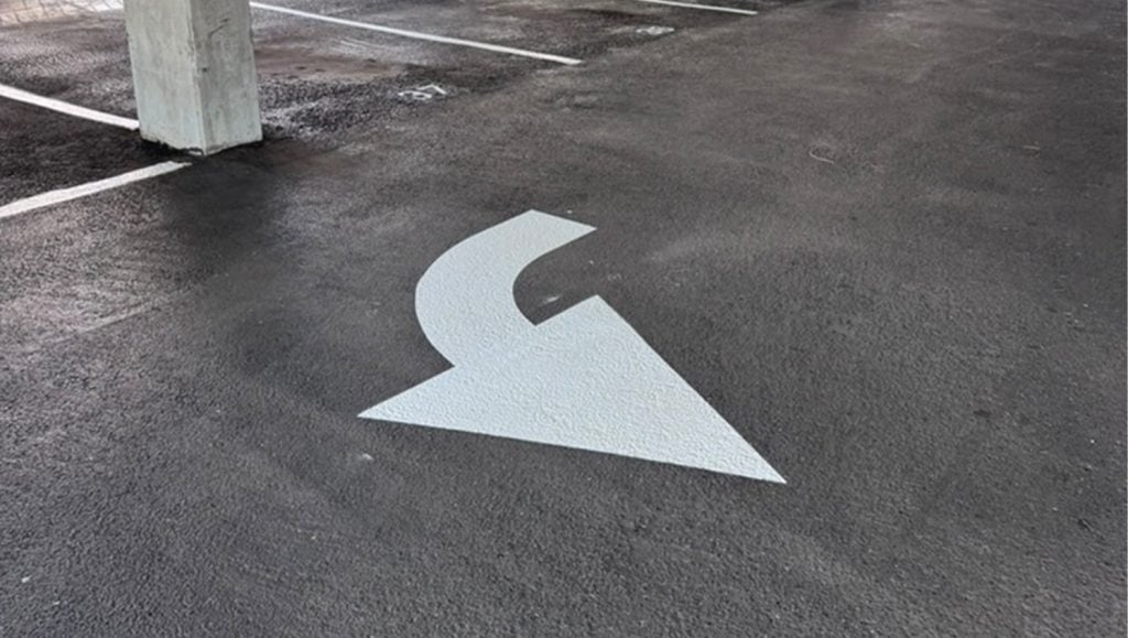freshly painted white arrow for Parkland Gardens Condominium parking lot