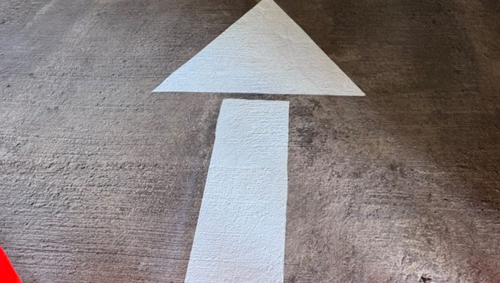 close-up freshly painted white arrow