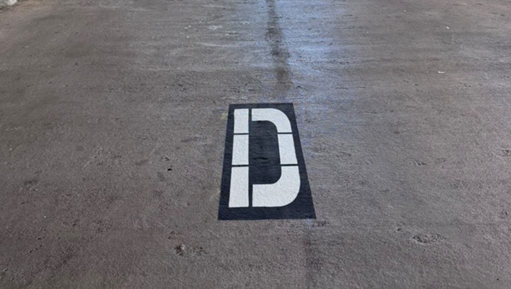 close-up "d" freshly painted on Parkland Gardens Condominium parking lot