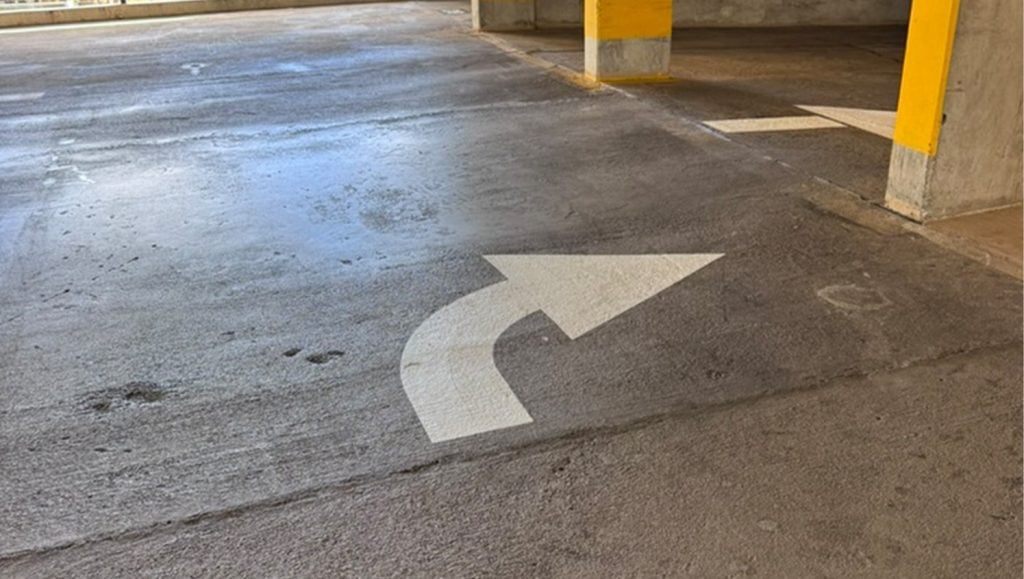 freshly painted arrow for Parkland Gardens Condominium parking lot
