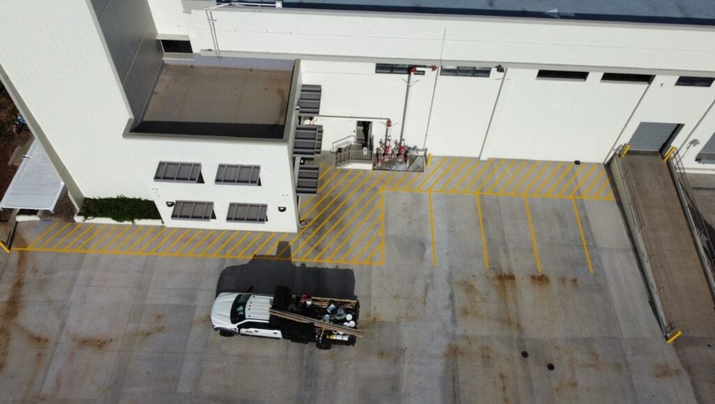 line markings freshly painted for Freight Company parking lot aerial view