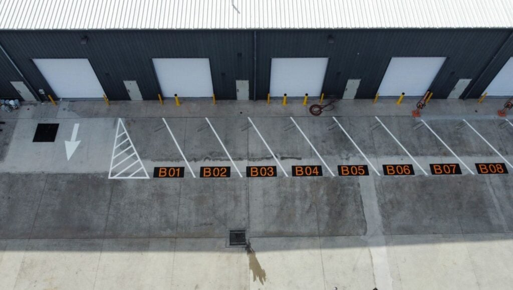parking spots freshly painted for SIXT Car Rental aerial view
