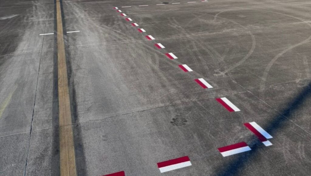 red and white line markings freshly painted for FedEx Airplane Ramp