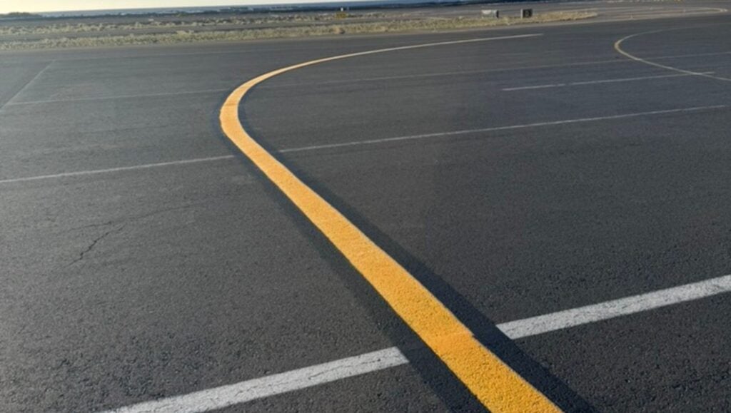 yellow line marking freshly painted for Traffic Associated Marking Systems parking lot