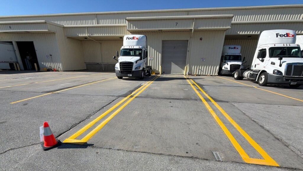 front view of FedEx warehouse with freshly painted line markings