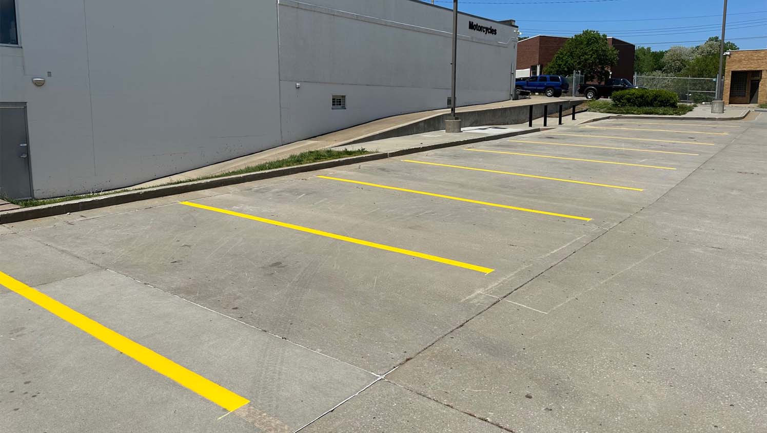 newly striped parking lot stalls on side of store