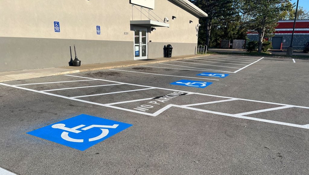 Freedom Plasma ada compliance parking spots faded before new line markings