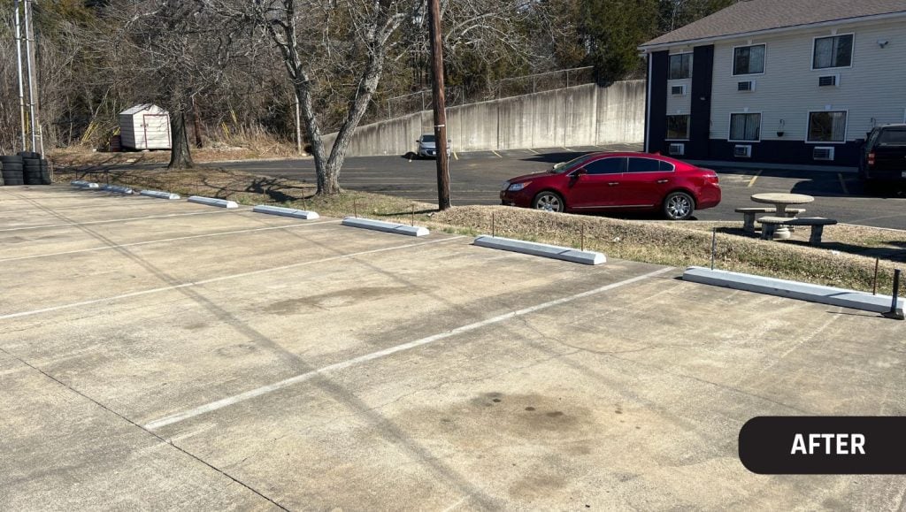 Joy Automotive parking lot with new parking stops installed