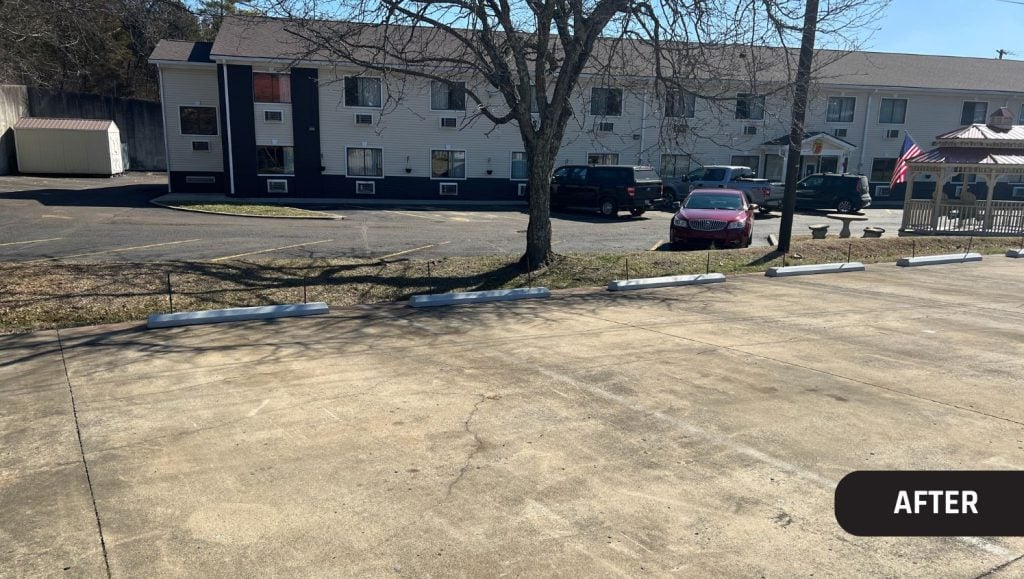 after portrait of Joy Automotive parking lot with parking stops installed