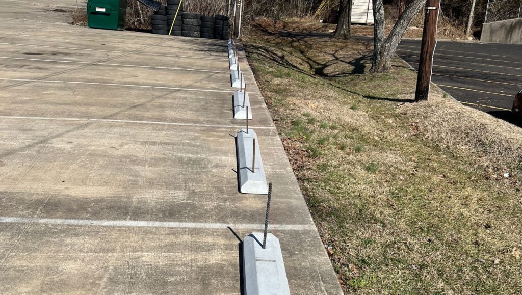 close-up of parking stops installed for Joy Automotive parking lot