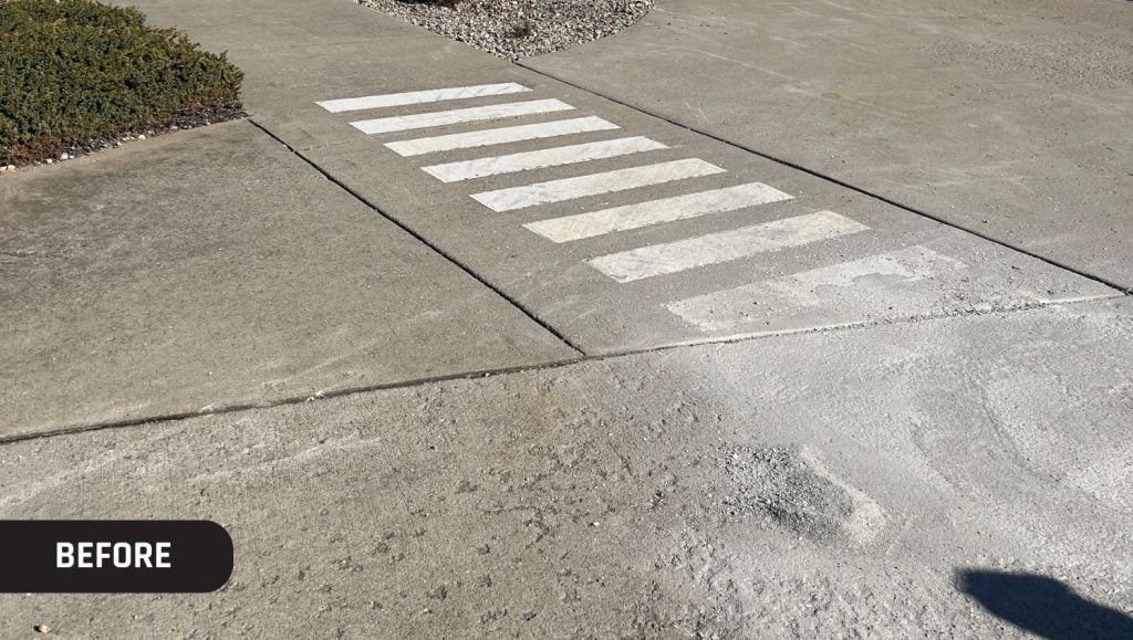 Kinemetrix parking lot with a faded crosswalk