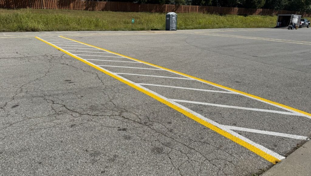 close-up of yellow and white line markings freshly painted for Sabert