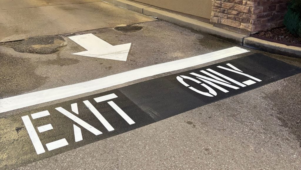 close-up of exit only freshly painted on taco bell parking lot