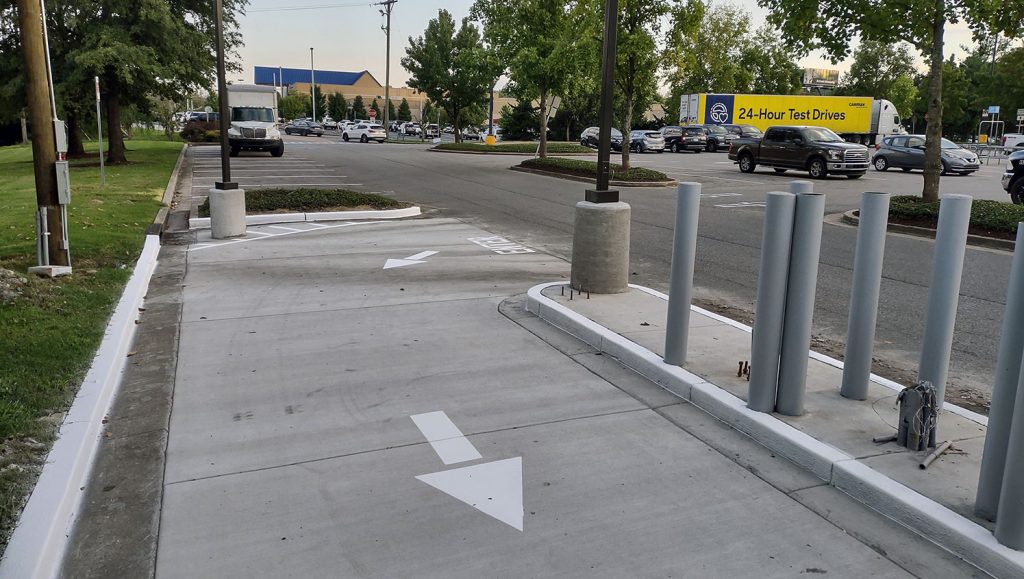 newly striped entrance sign and arrows