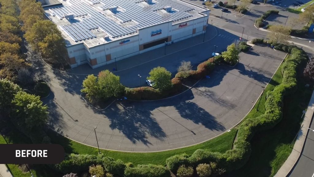 Divisions Inc. parking lot with no line markings aerial view