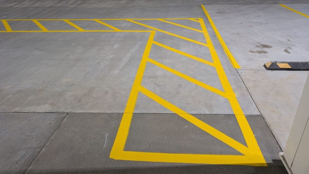 front view of O'Reilly Autoparts parking lot with freshly painted ada compliance parking spots