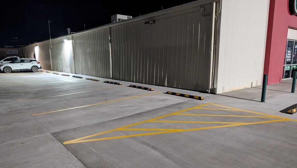 side view of O'Reilly Auto Parts parking lot freshly painted