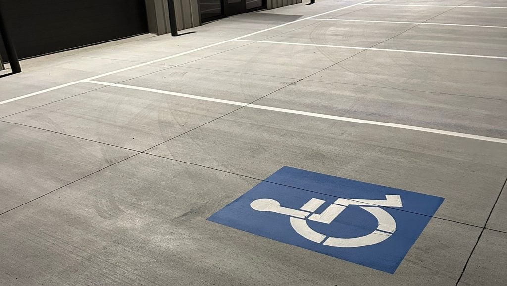 close-up of freshly painted white markings on parking lot for business park