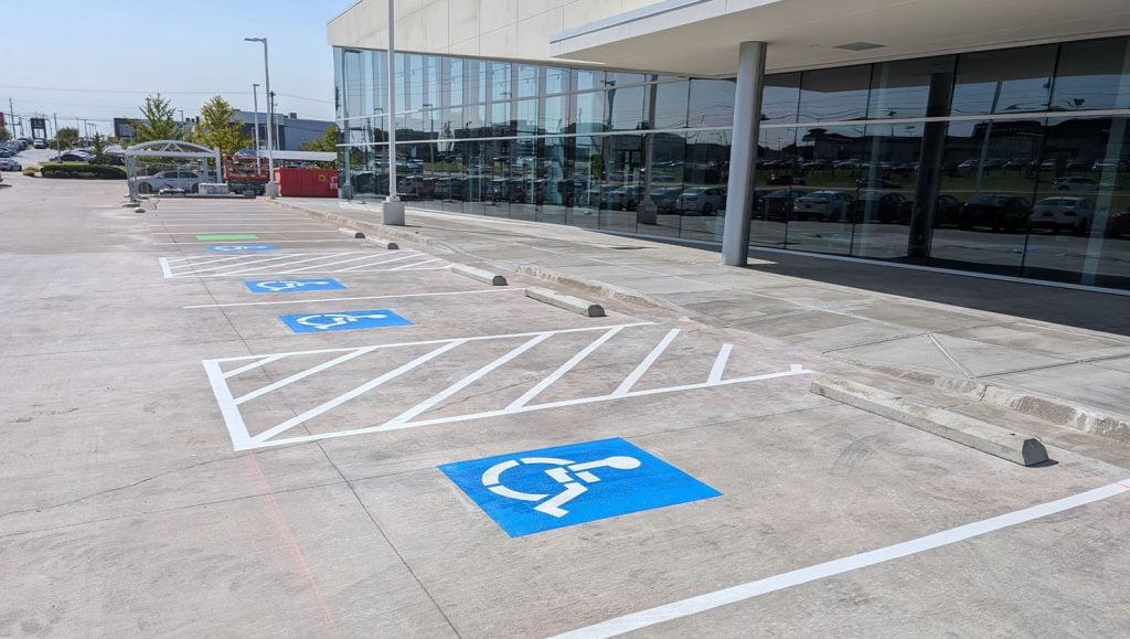 front view of business parking lot with freshly painted ada compliance parking spots
