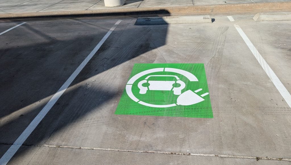 ev charging markings freshly painted for business parking lot