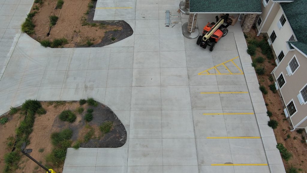 Cobblestone Hotel hotel parking lot aerial view with fresh line markings