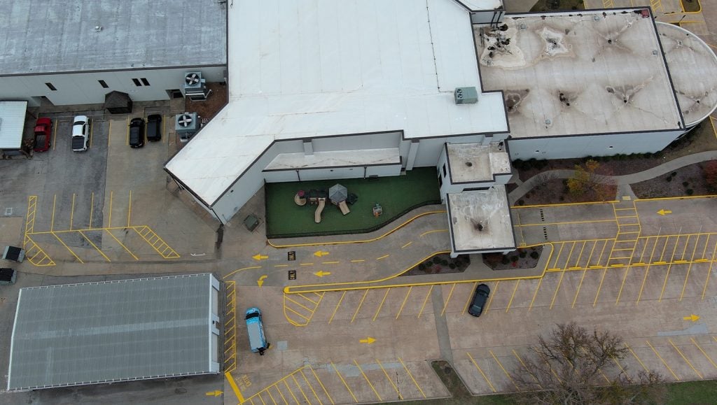 aerial view of Owasso First Assembly Church with freshly painted line markings