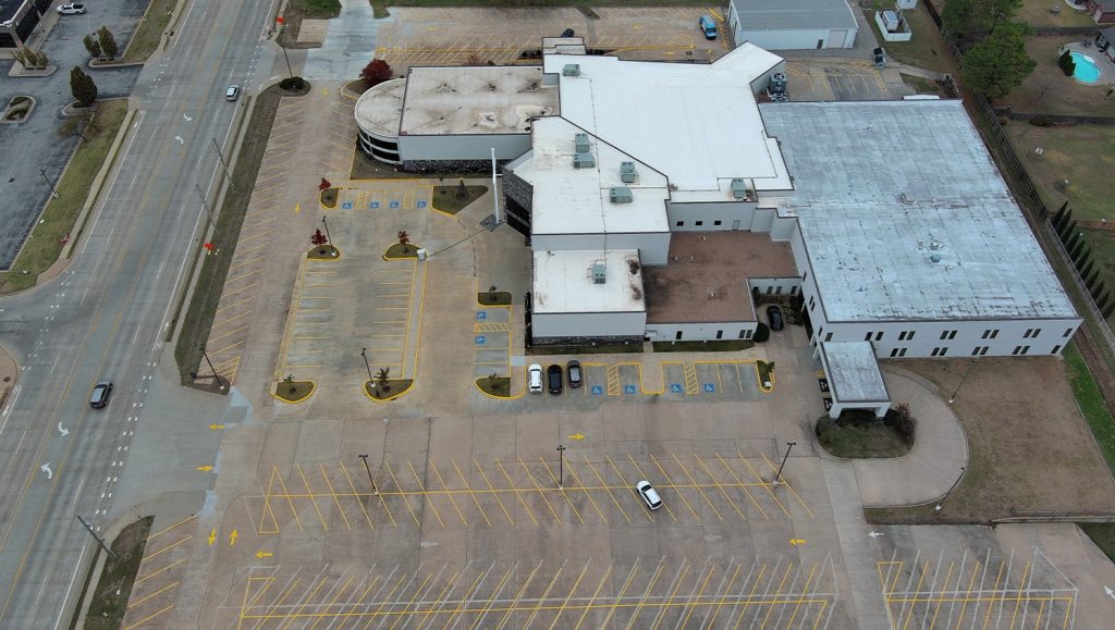 aerial view of Owasso First Assembly Church parking lot freshly painted