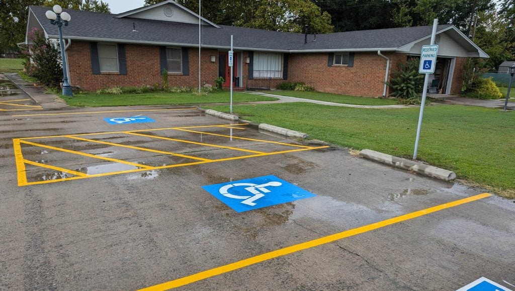 ada compliance parking spots freshly painted for Stigler Primary Care Clinic parking lot