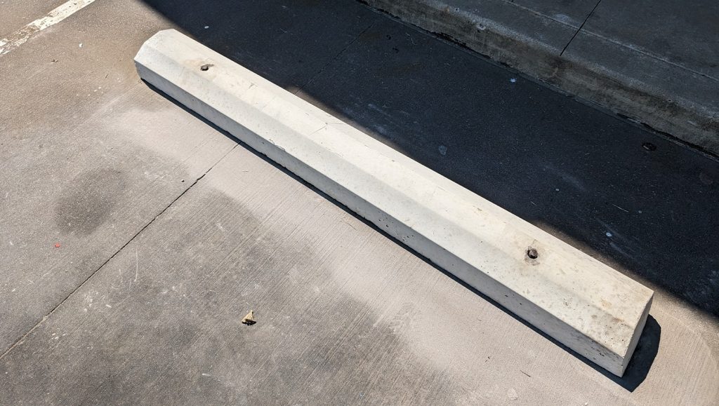 close-up of new parking stop on parking lot