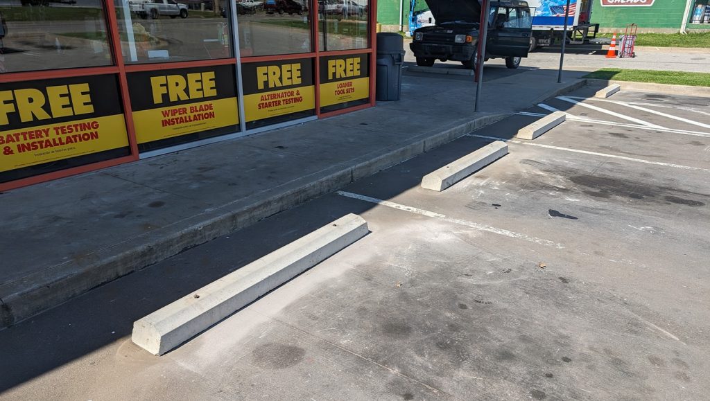 advanced auto parts parking lot with new parking stops