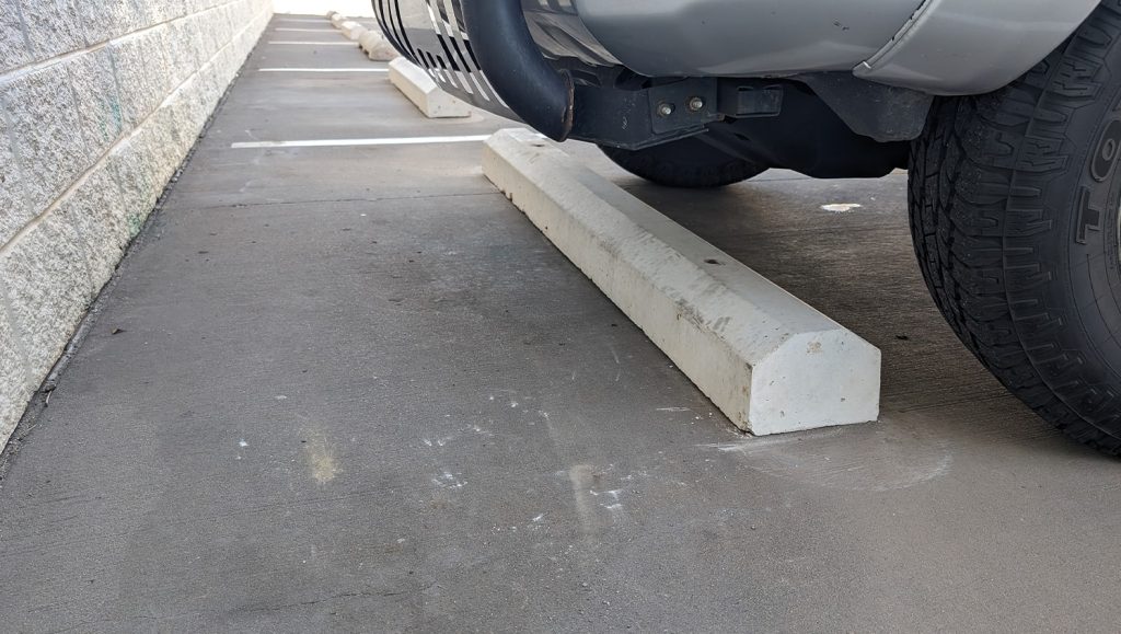 close-up of parking stop for advanced auto parts parking lot