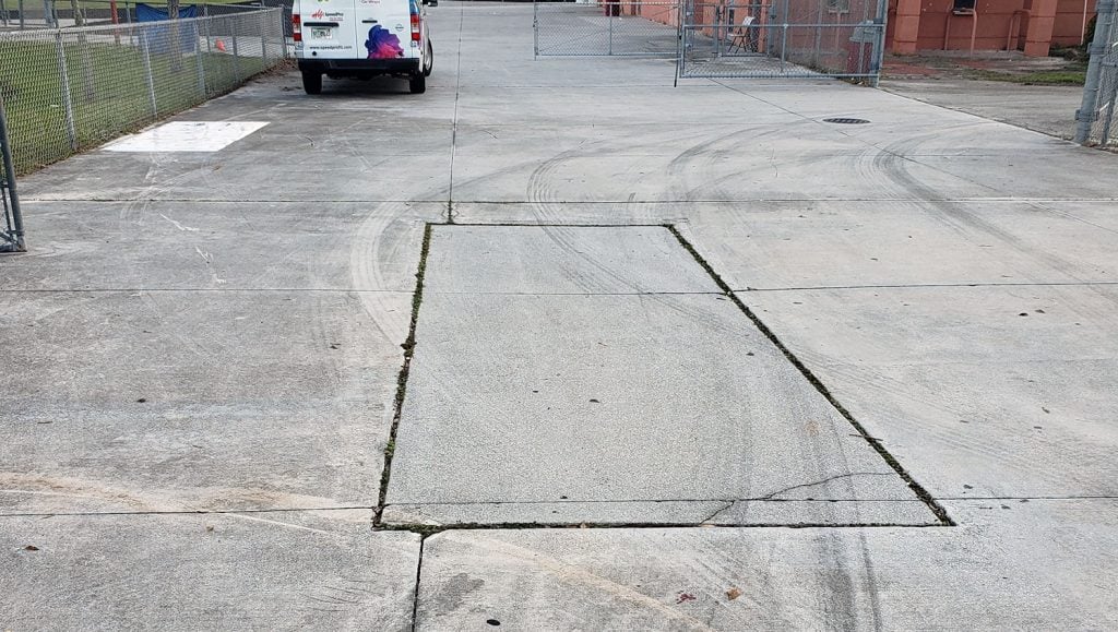 completed custom logo line striping at football field entrance