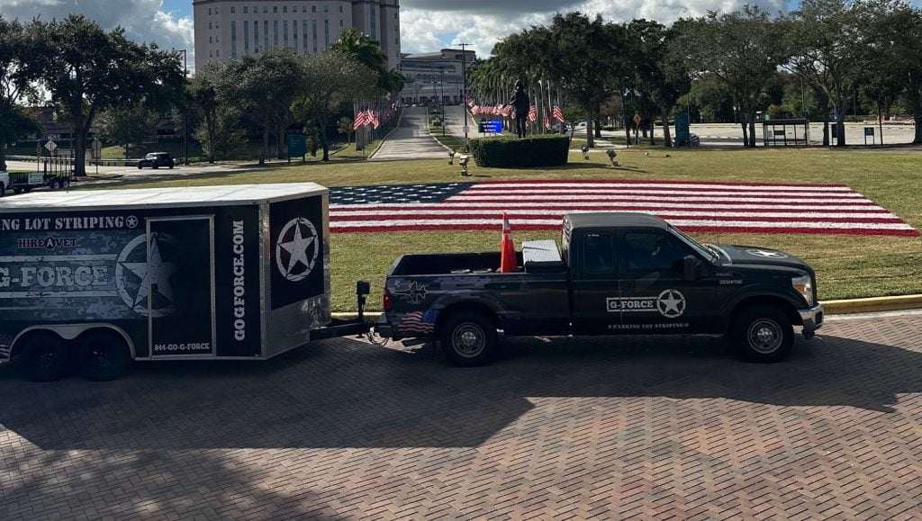 G-FORCE employees painting american flag on athletic field