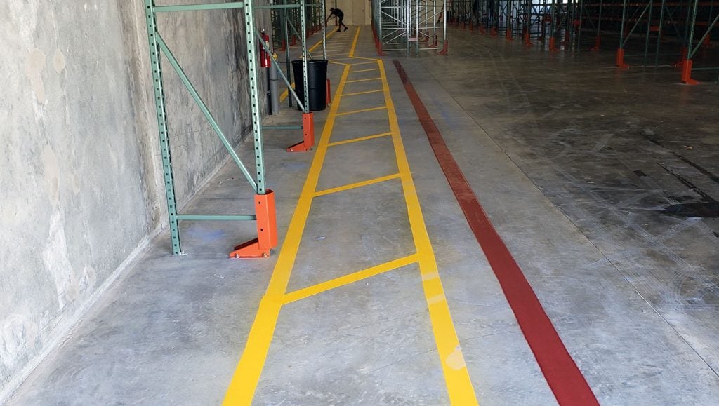 yellow safety lane markings in aisle of new warehouse