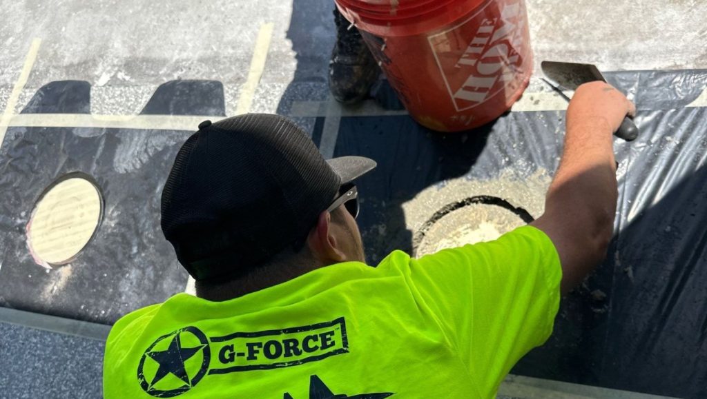 G-FORCE® employee installing bollards for private customer