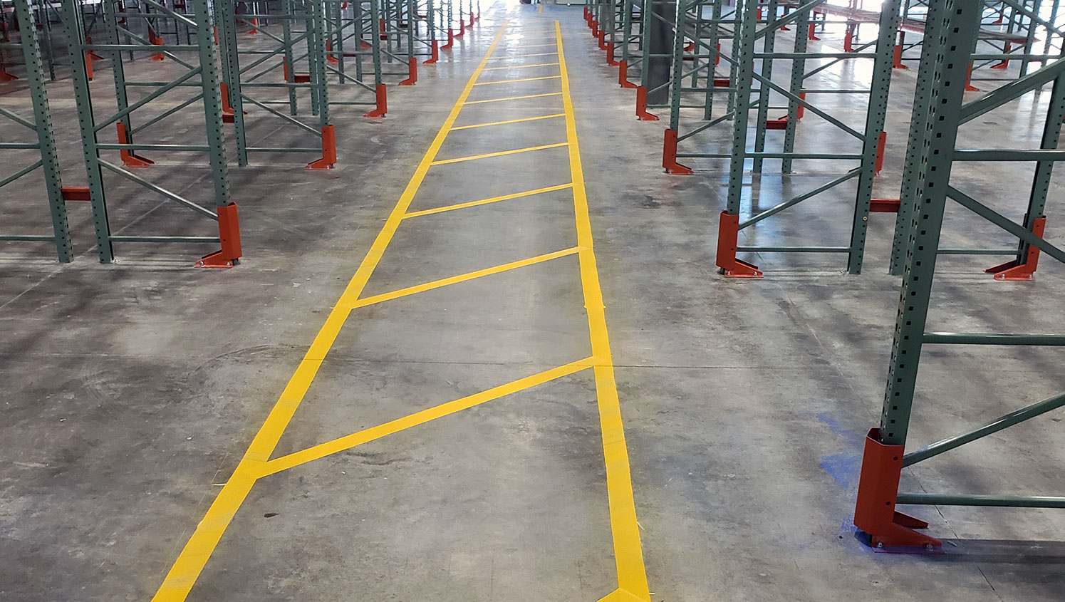 yellow safety lane markings in aisle of new warehouse