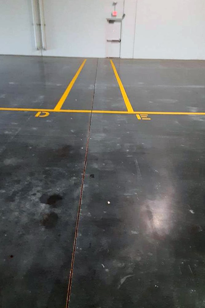 new warehouse floor markings with “D” and “E” symbols