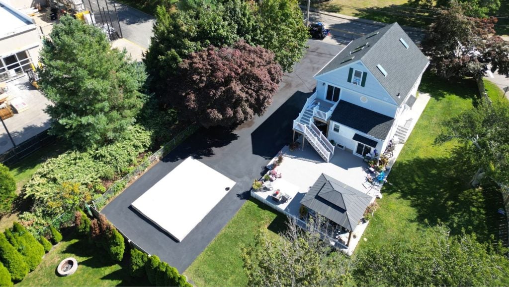 aerial view of Residential Home with new asphalt sealcoating driveway