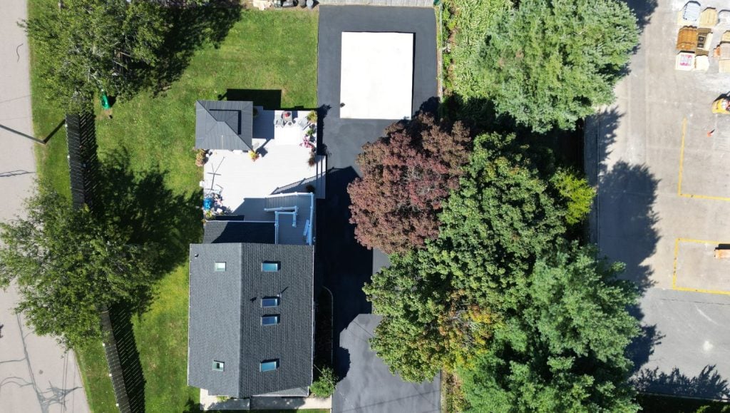 Residential Home with new asphalt sealcoating driveway aerial view