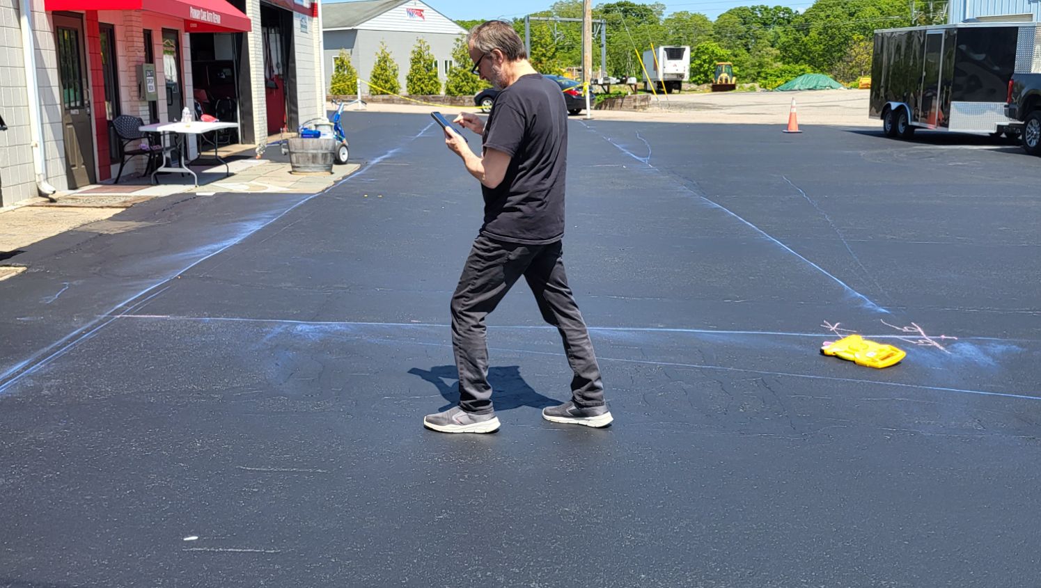 a man standing on an asphalt lot