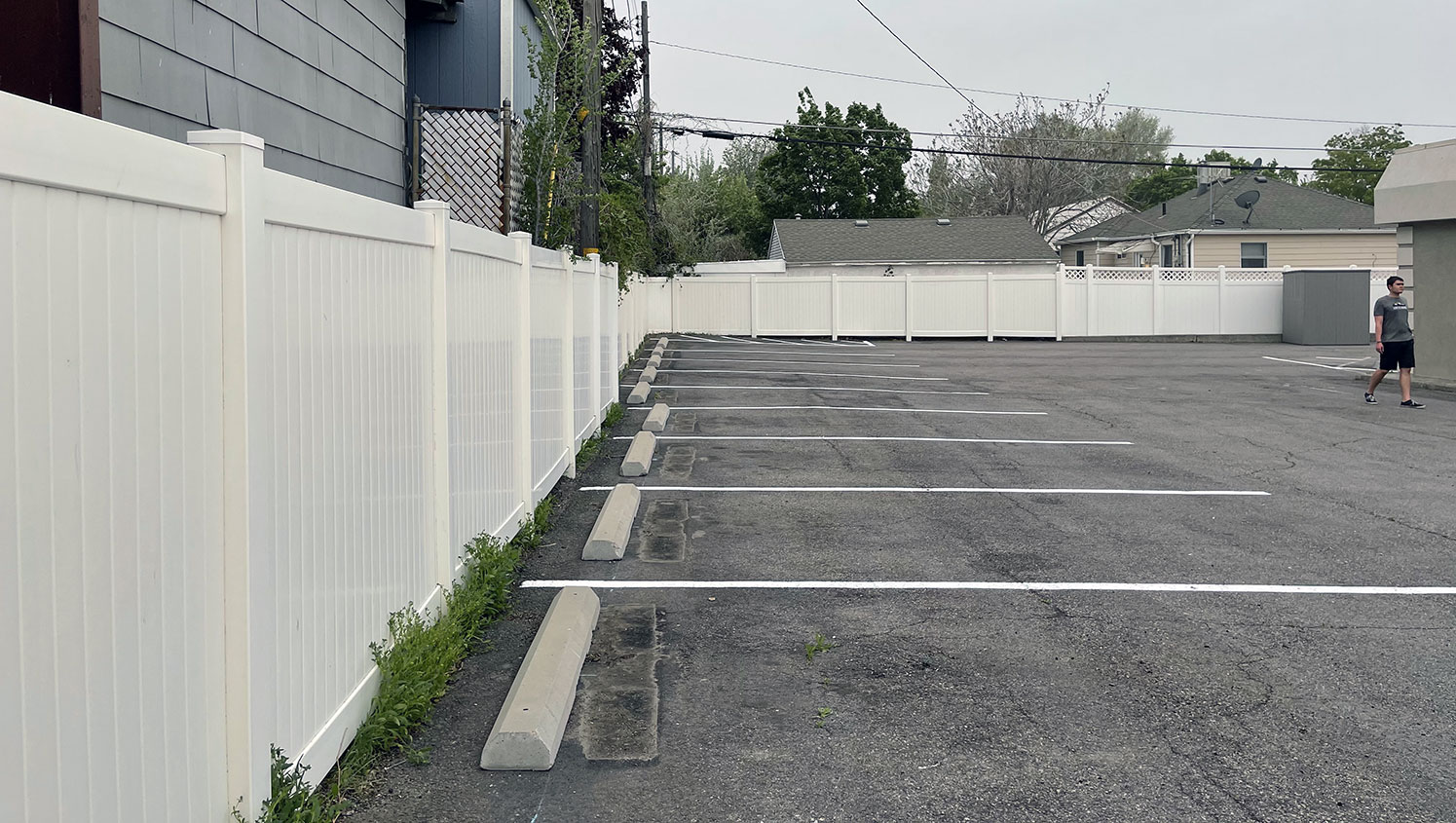 before and after photos showcasing Rising Health Specialty Clinic’s restriped parking lot