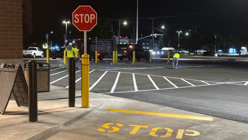 freshly painted cross walk and stop sign installation for Harmon’s Grocery