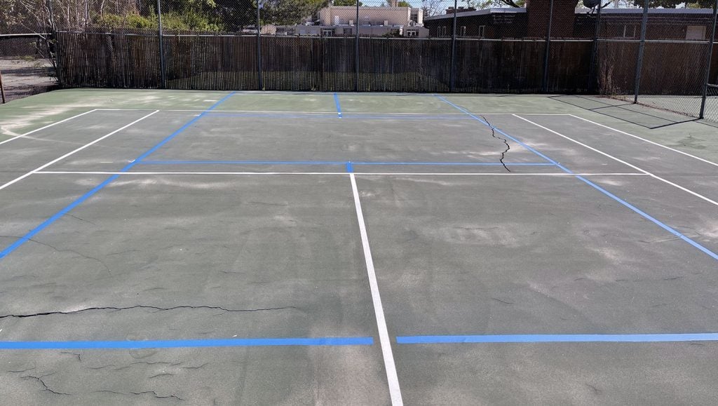 before and after shots of Evergreen Swim and Tennis Club’s pickleball court striping project in Salt Lake City, UT.