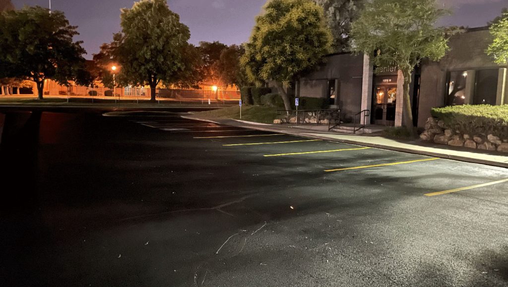 fresh asphalt sealcoating at night in west valley city, ut