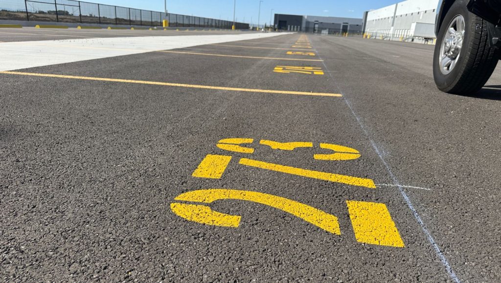 close-up of yellow line markings freshly painted for New Balance Distribution Center parking lot