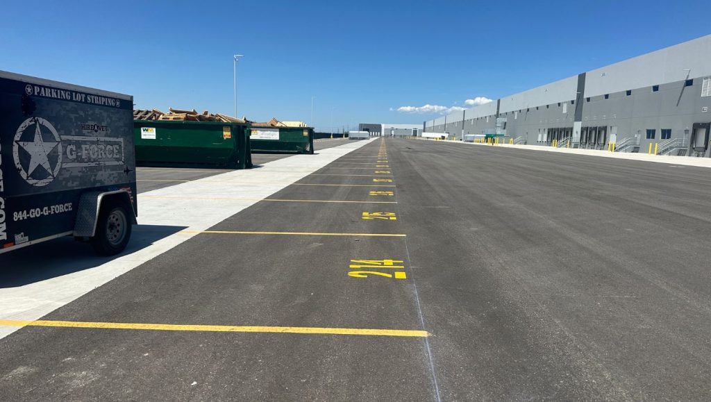 yellow parking spots freshly painted for New Balance Distribution Center parking lot