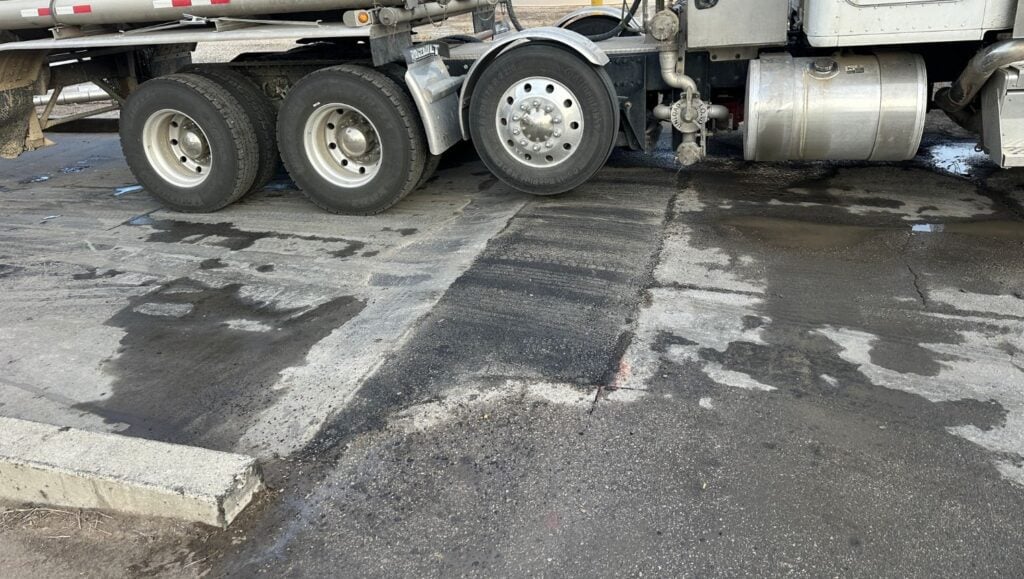truck going over freshly poured asphalt patch for Chevron parking lot