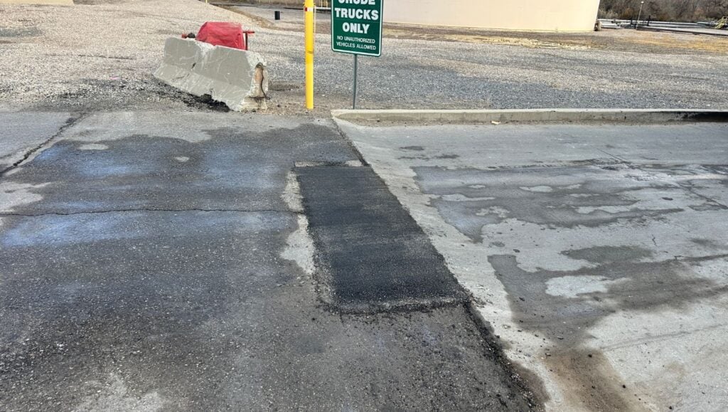 asphat patch freshly poured for Chevron parking lot close-up