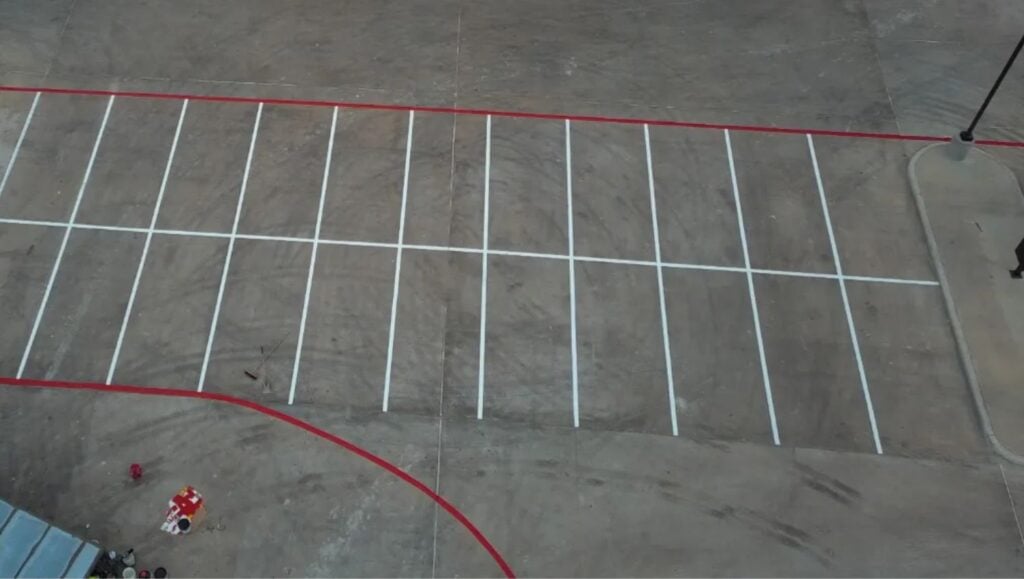 parking spots freshly painted for HEB Fuel parking lot aerial view